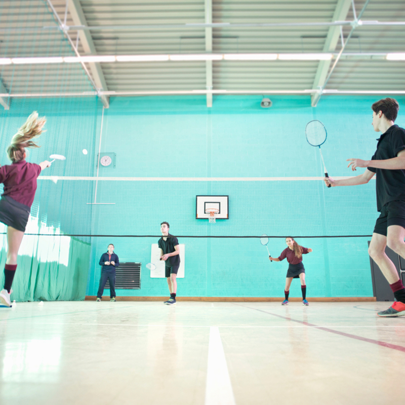 A group of teenagers playing badminton
