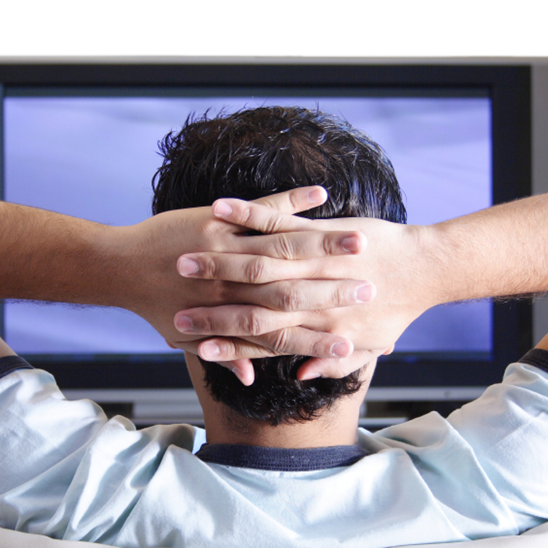 Man sat on sofa watching TV