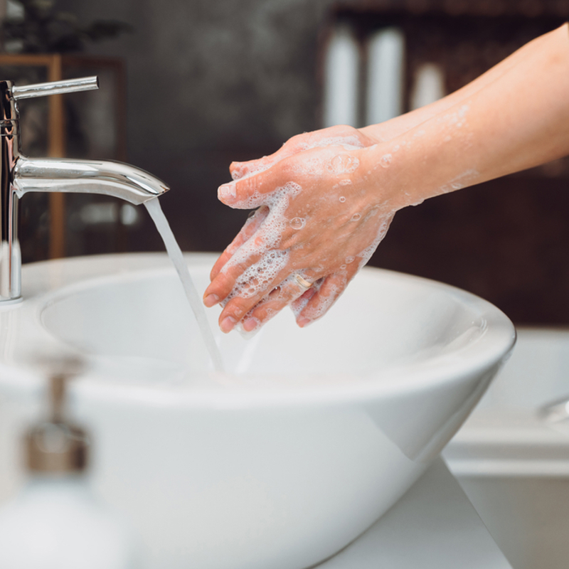Pregnant woman washing her hands