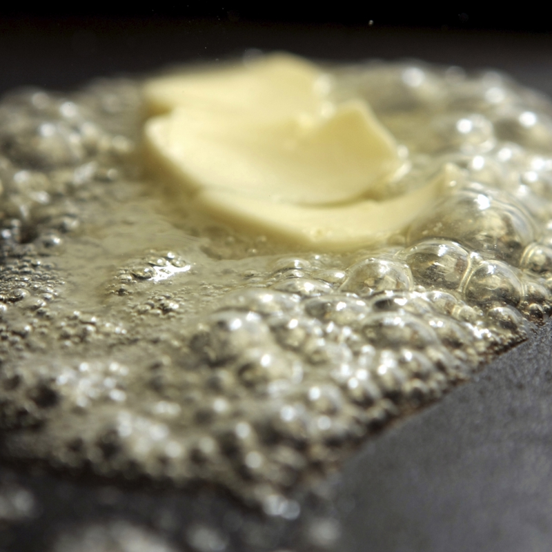 Butter melting in a frying pan