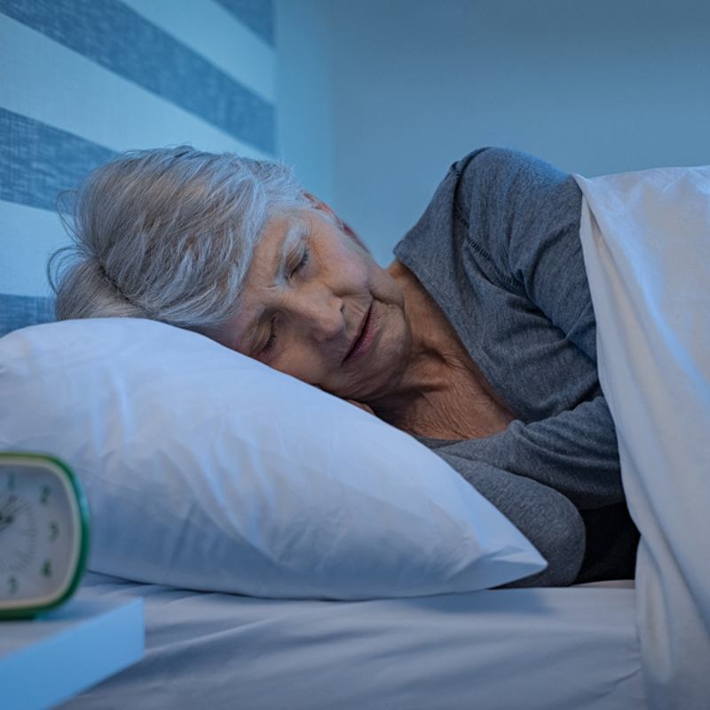 An older woman in bed sleeping
