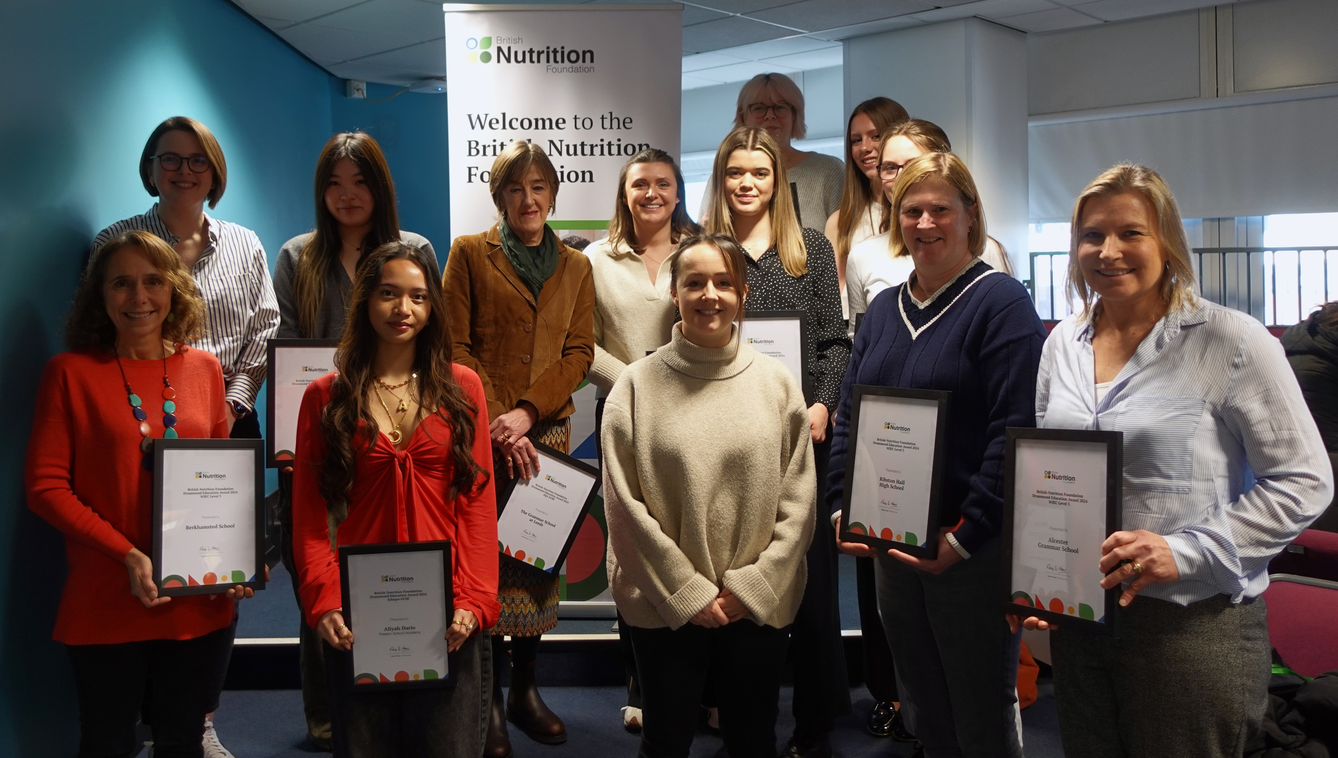 A photo of teachers and pupils at the Education Conference, with their awards loading=