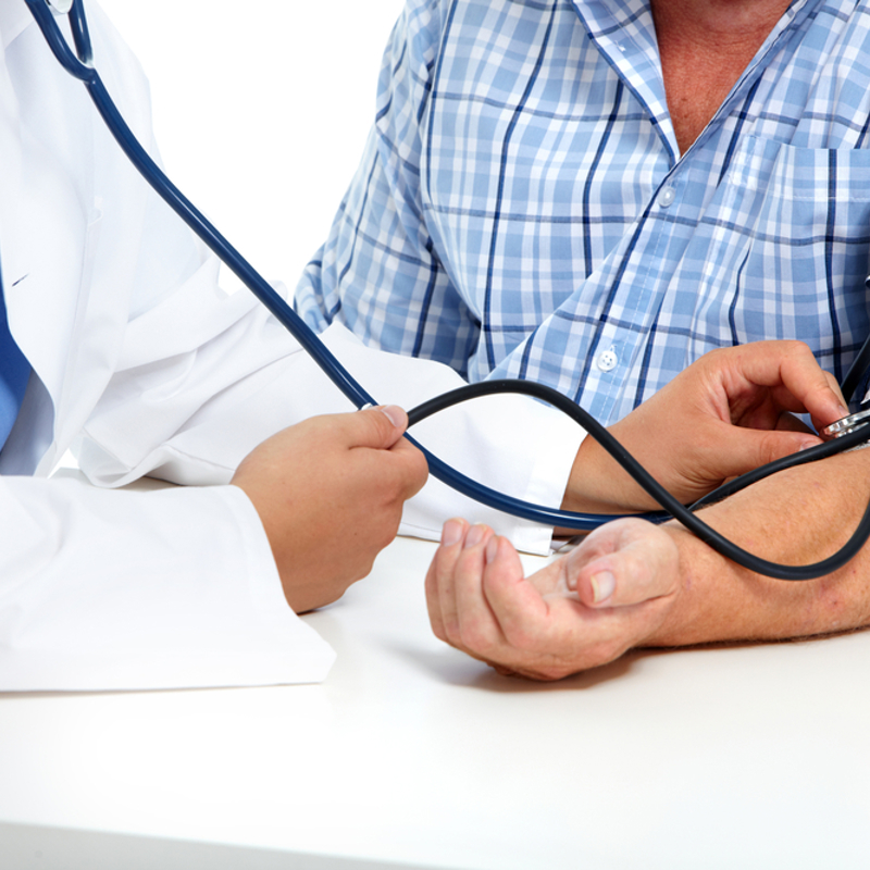 A doctor checking the blood pressure of a man