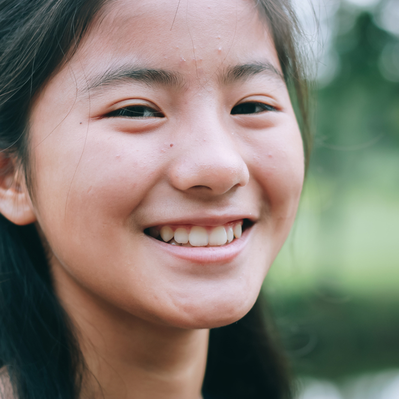 A teenage girl smiling