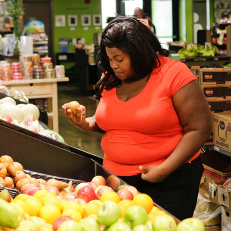 A woman choosing food in a supermarket