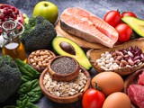 A photo of raw ingredients that represent a healthy balanced diet, on a wooden surface